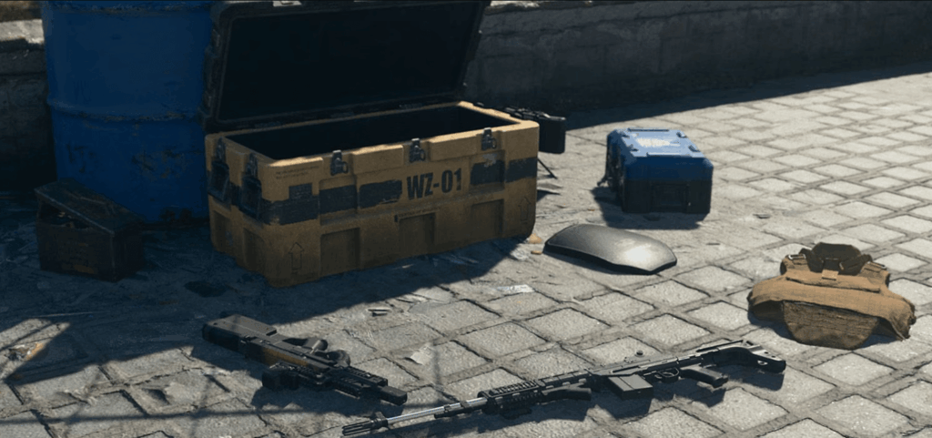 uma caixa com armas e uma arma no chão